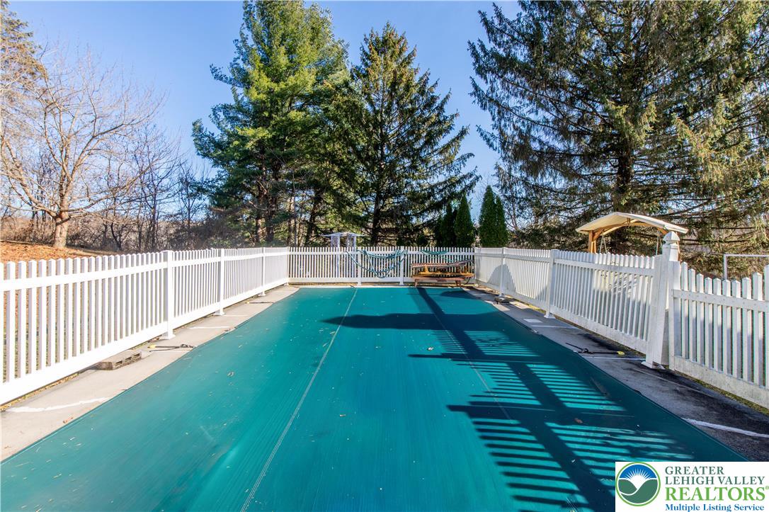 501 Creek Road Bath, PA 18014 - Photo 37 of 50 a view of yard with swimming pool and trees in the background