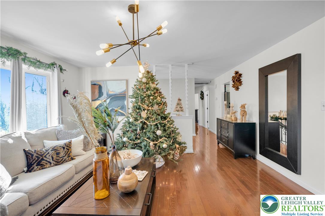 501 Creek Road Bath, PA 18014 - Photo 9 of 50 a living room with furniture and a chandelier