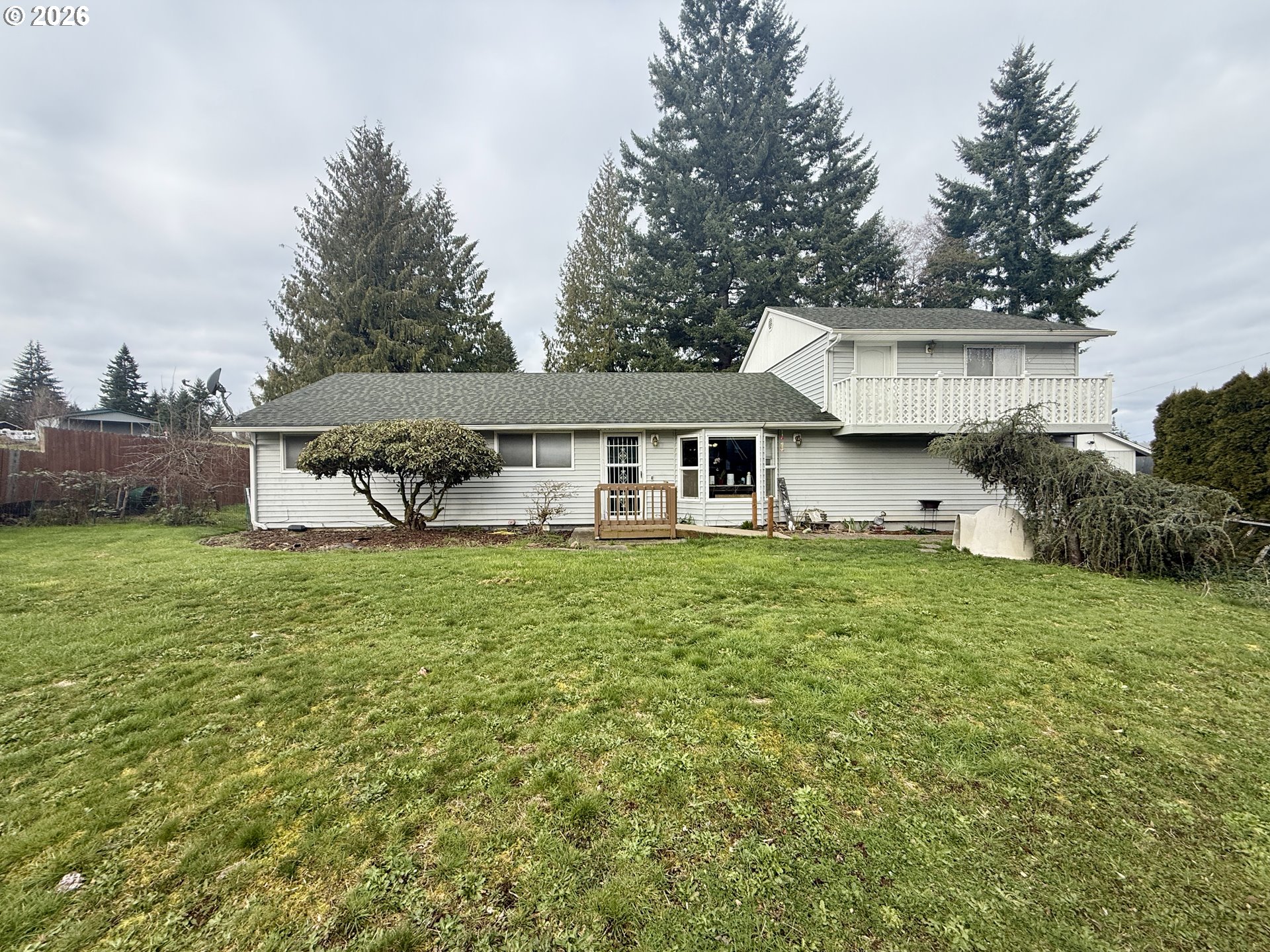 105 Timberline Drive Castle Rock, WA 98611 - Photo 3 of 21 a front view of a house with a yard and trees