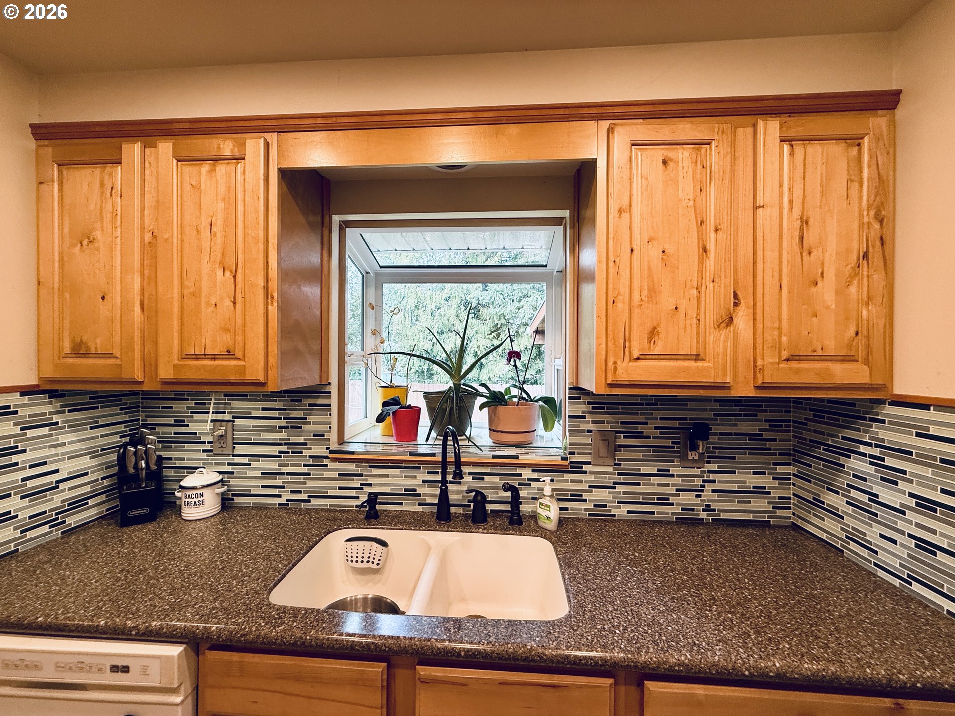 105 Timberline Drive Castle Rock, WA 98611 - Photo 8 of 21 a kitchen with granite countertop a sink a window and cabinets