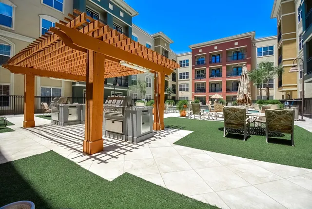 a outdoor space with lots of tables a garden and a stove
