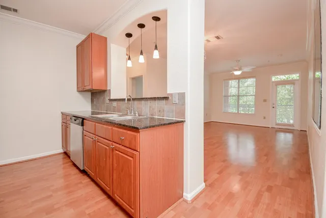 a bathroom with sink a mirror and wooden floor