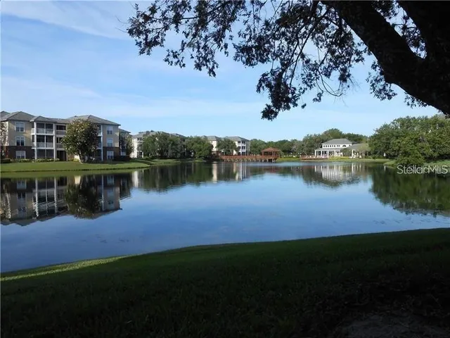 a view of a lake with houses in the back