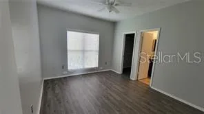 an empty room with wooden floor and a window
