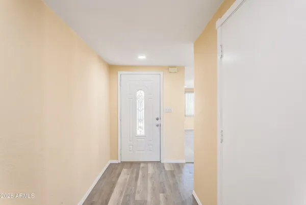 a view of a hallway with wooden floor