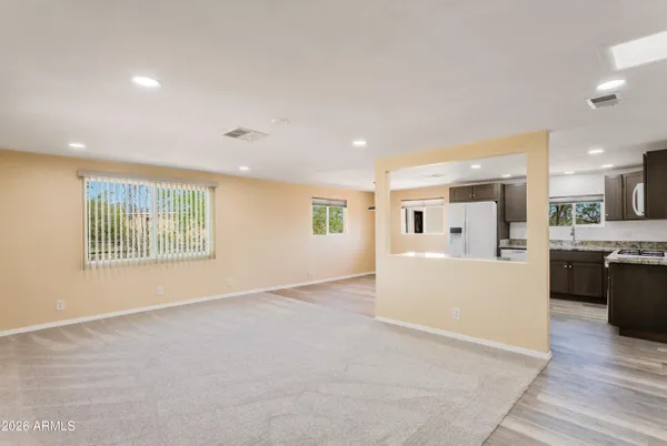 a view of work space with wooden floor and windows