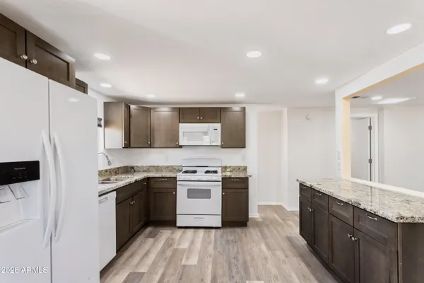 a kitchen with a stove a sink and a refrigerator