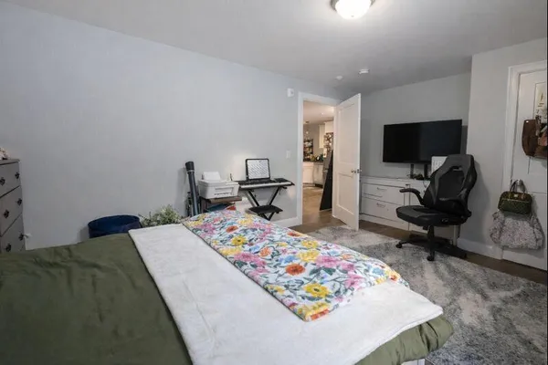 a bed sitting in a bedroom next to a window
