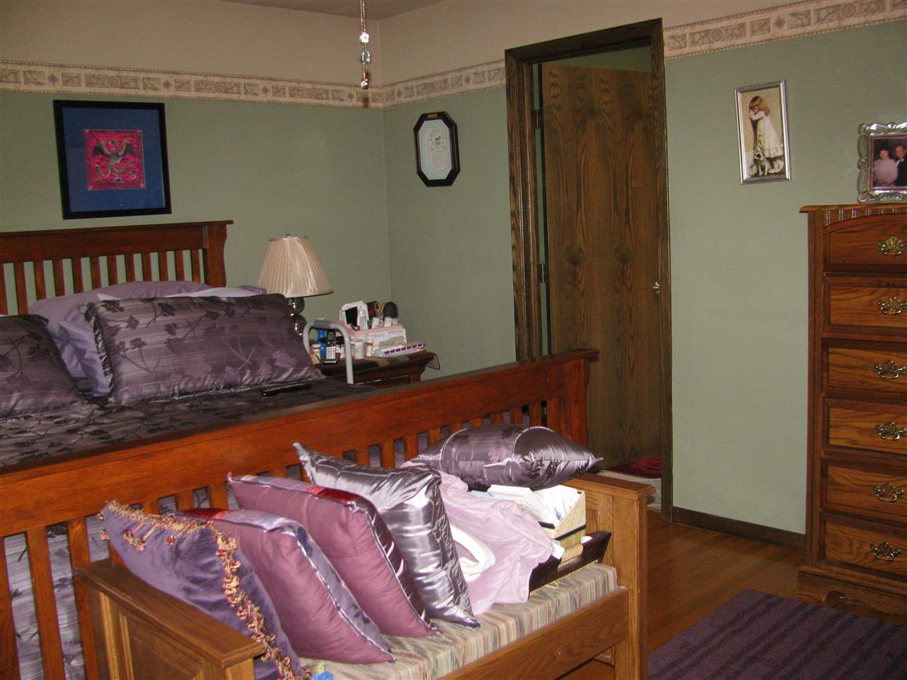 572 Baintree Road Lake Summerset, IL 61019 - Photo 16 of 24 a bed sitting in a bedroom next to a window and wooden floor