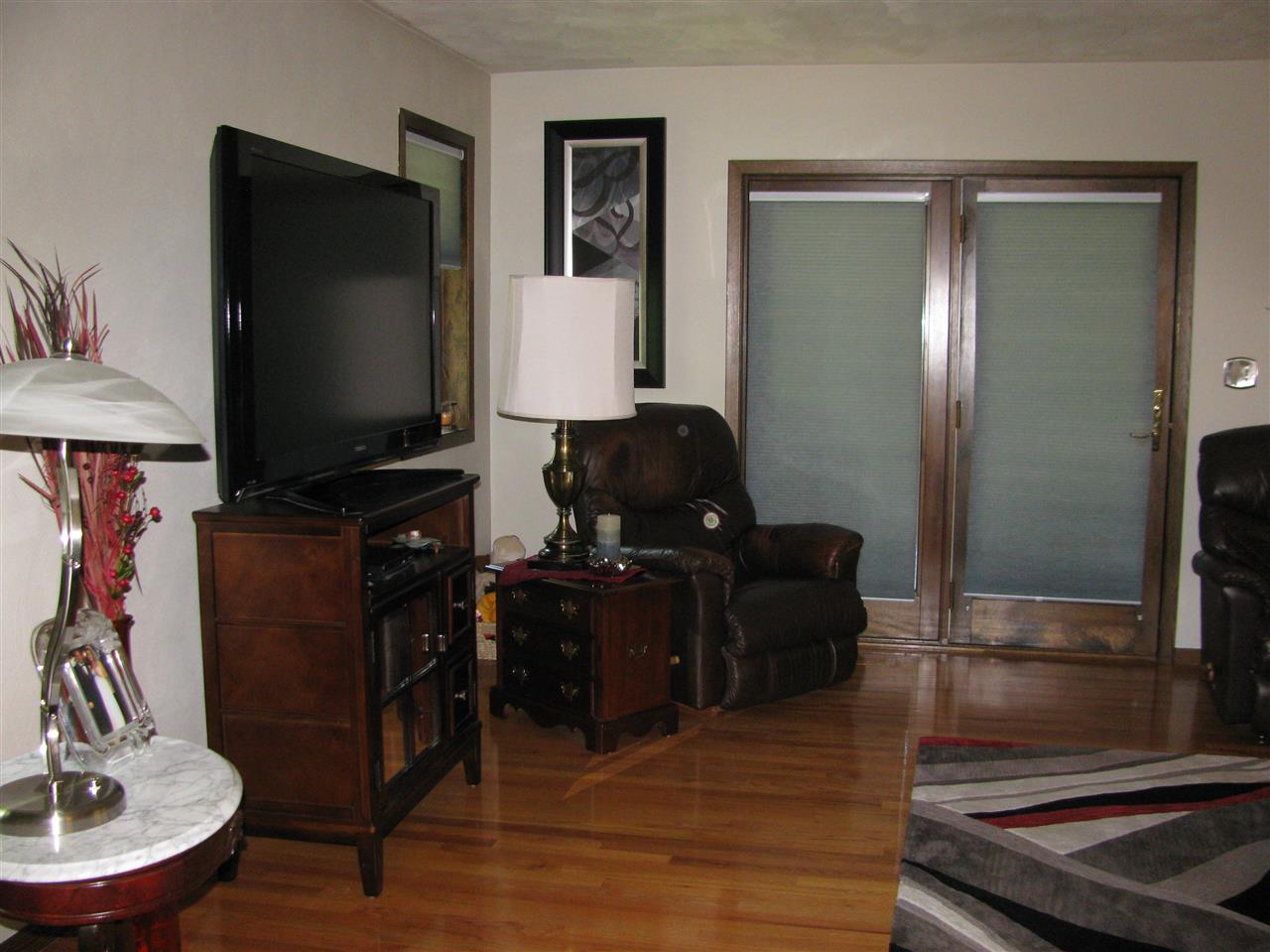 572 Baintree Road Lake Summerset, IL 61019 - Photo 6 of 24 a living room with furniture and a flat screen tv