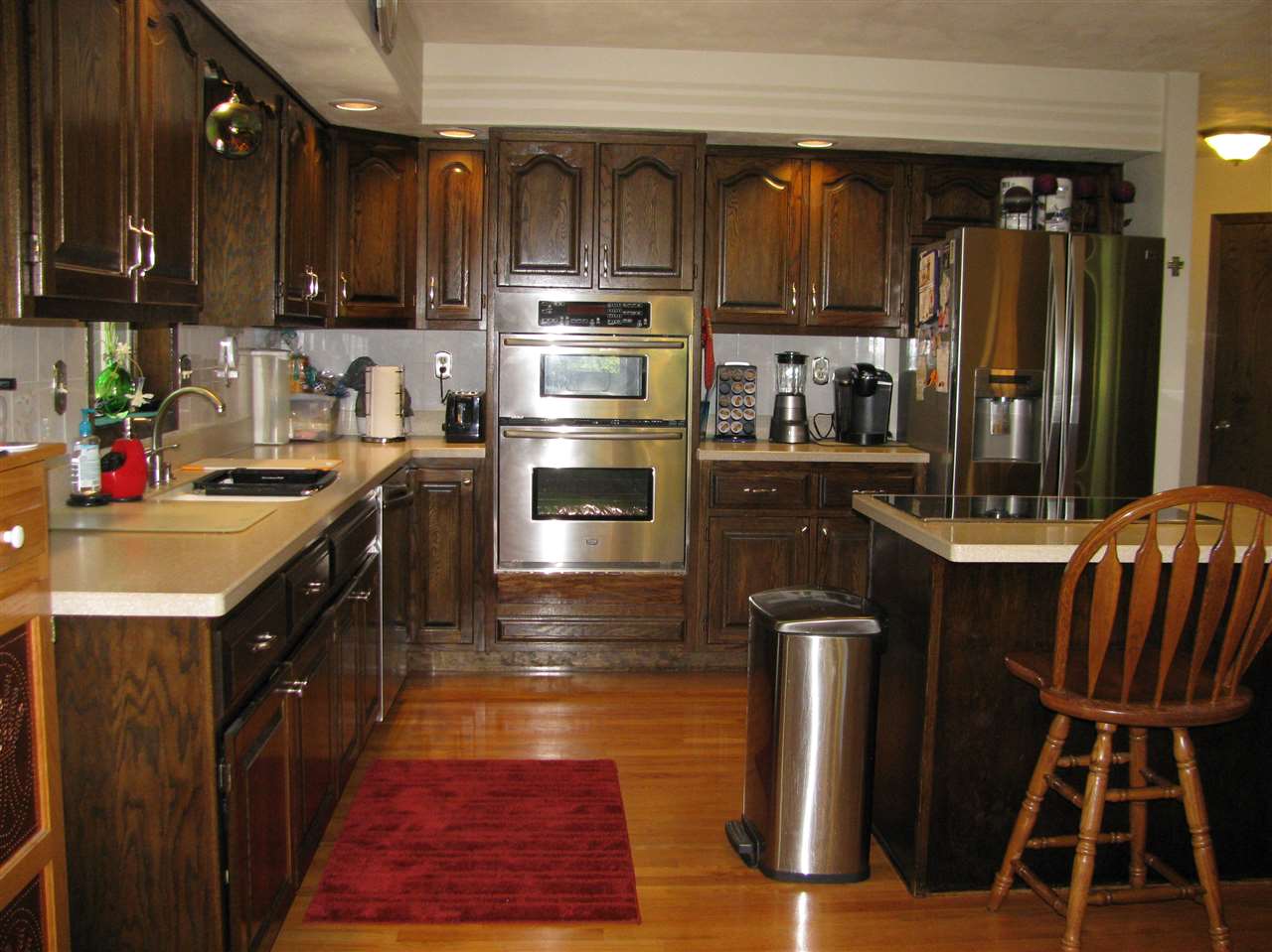 572 Baintree Road Lake Summerset, IL 61019 - Photo 10 of 24 a kitchen with granite countertop a stove top oven a refrigerator a sink dishwasher and wooden cabinets with wooden floor