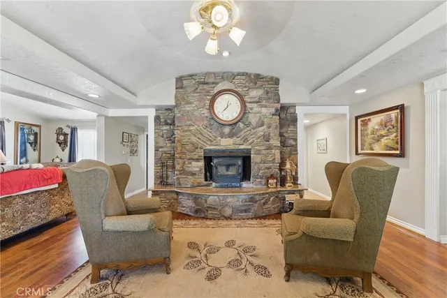 a kitchen with stainless steel appliances granite countertop a table chairs and a refrigerator