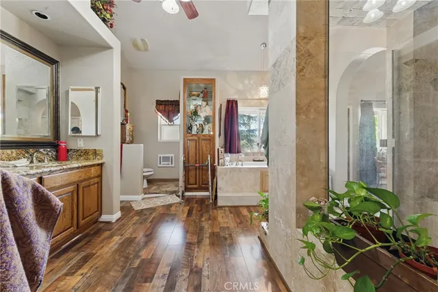a bedroom with a bed a chandelier and dresser