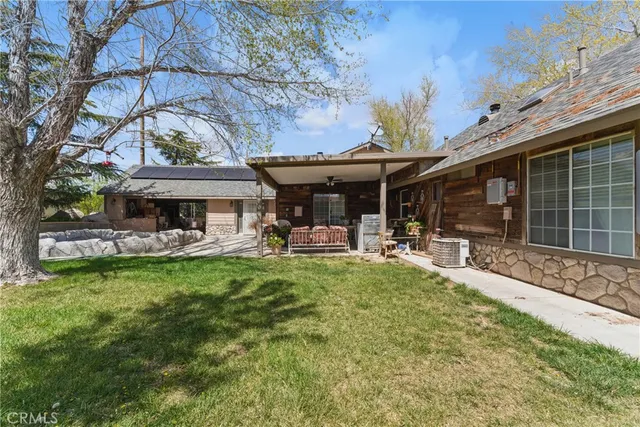 a view of residential house with outdoor space and lake view