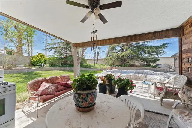 a view of a house with backyard porch and sitting area