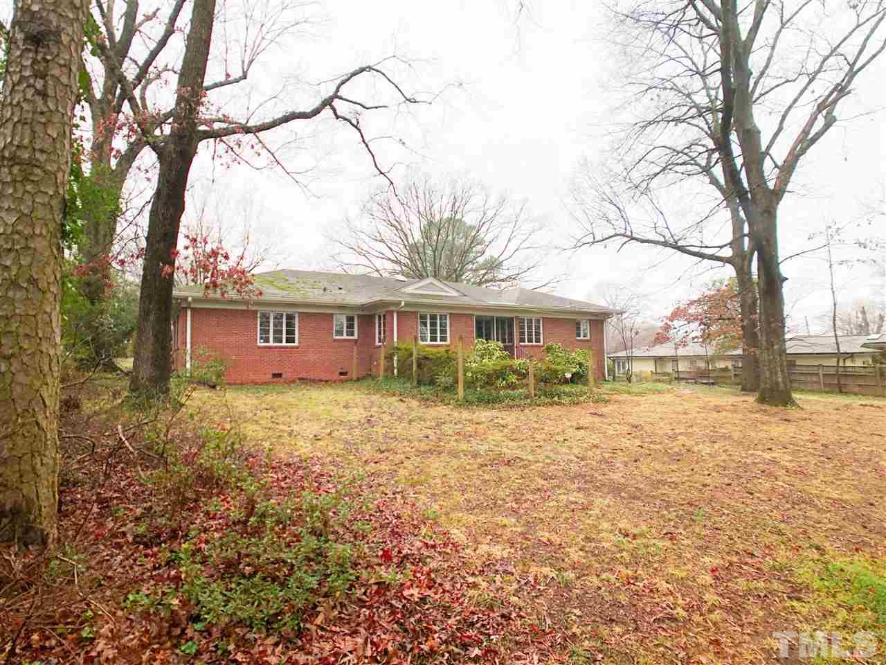 814 Woodburn Road Raleigh, NC 27605 - Photo 3 of 12 a view of a yard in front of a house with large trees