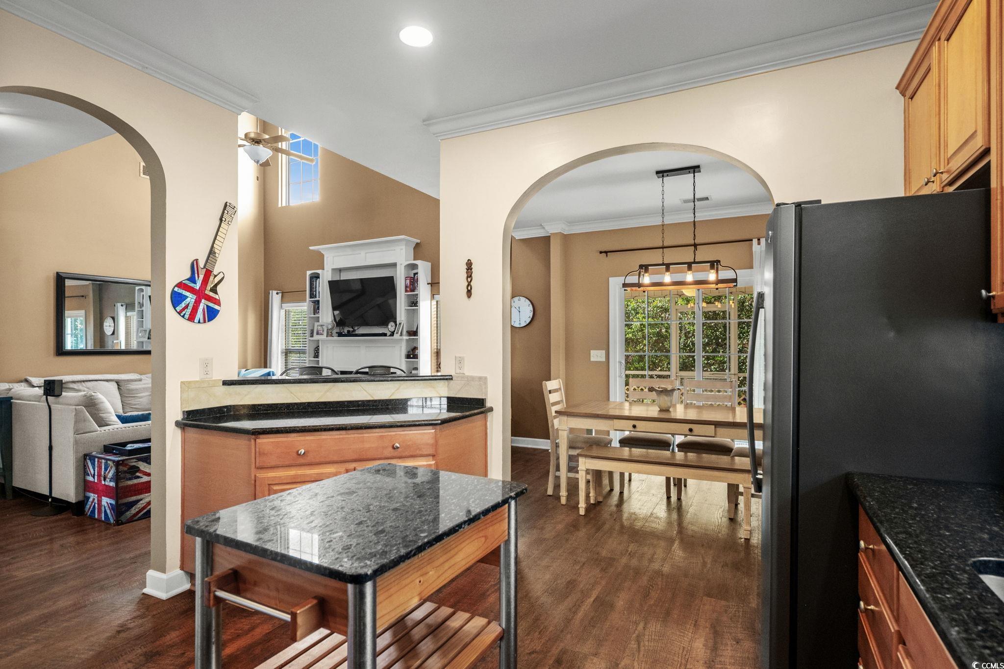 318 Barlow Court Conway, SC 29526 - Photo 36 of 36 Kitchen featuring arched walkways, open floor plan, freestanding refrigerator, and crown molding