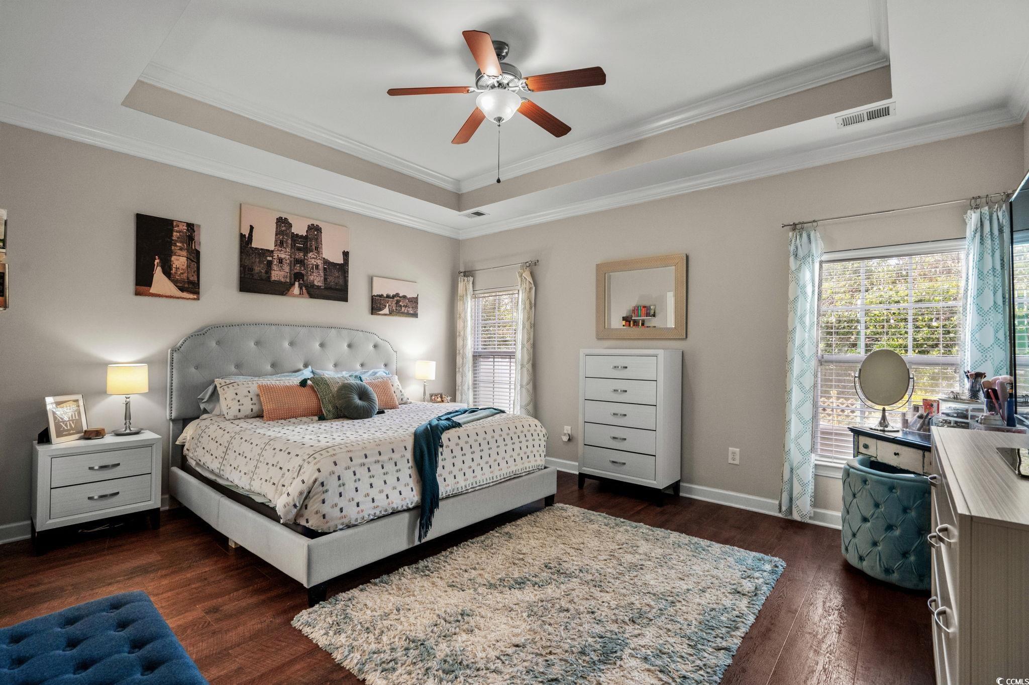 318 Barlow Court Conway, SC 29526 - Photo 14 of 36 Bedroom featuring dark wood-style flooring, a raised ceiling, crown molding, and a ceiling fan