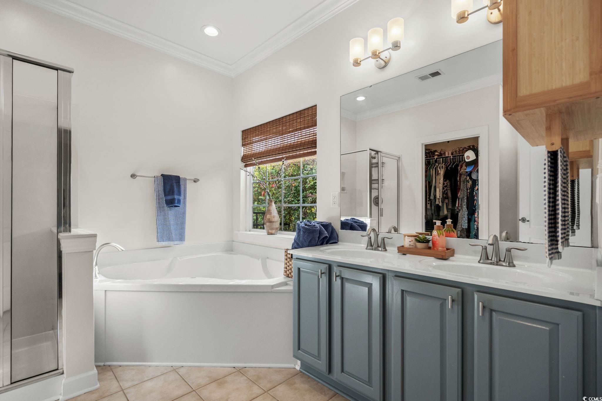 318 Barlow Court Conway, SC 29526 - Photo 15 of 36 Bathroom with double vanity, ornamental molding, a garden tub, a spacious closet, and a shower stall