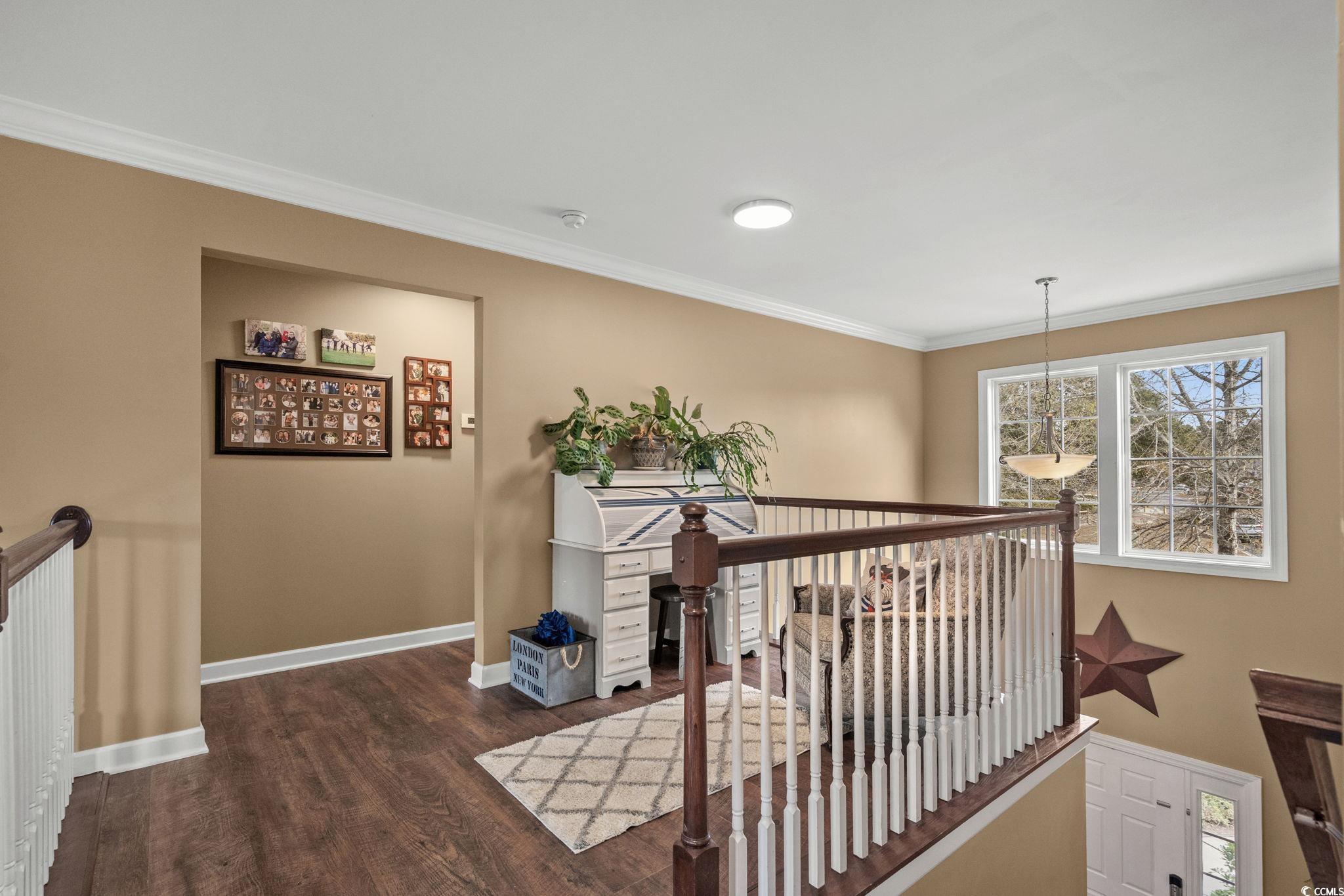 318 Barlow Court Conway, SC 29526 - Photo 16 of 36 Hallway featuring an upstairs landing, ornamental molding, and dark wood-style floors