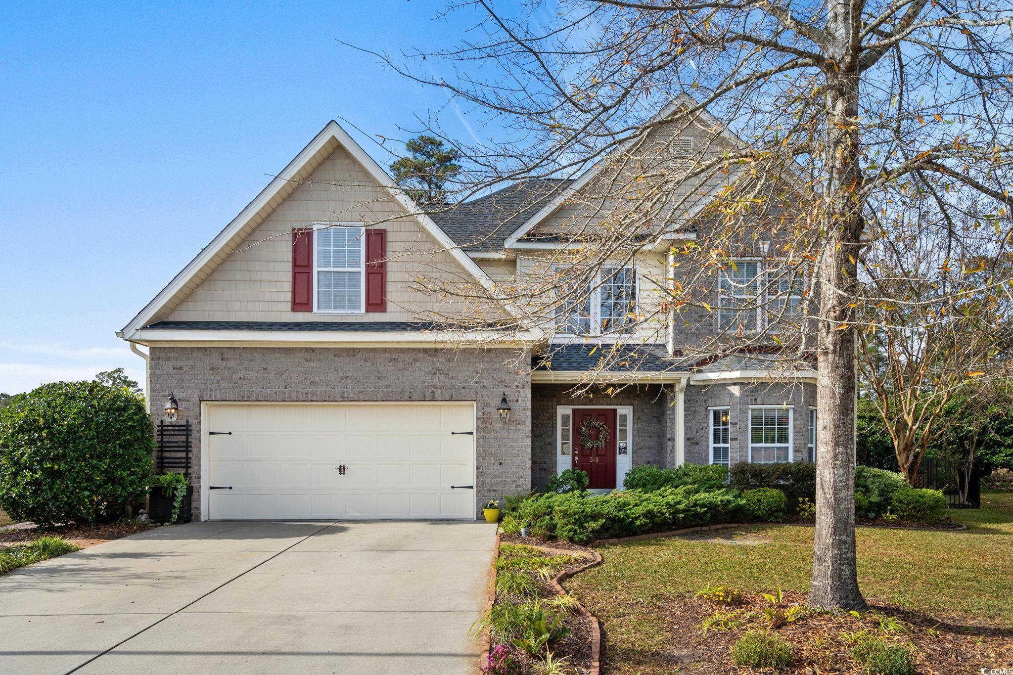 318 Barlow Court Conway, SC 29526 - Photo 2 of 36 View of front facade featuring an attached garage, driveway, a front lawn, and brick siding