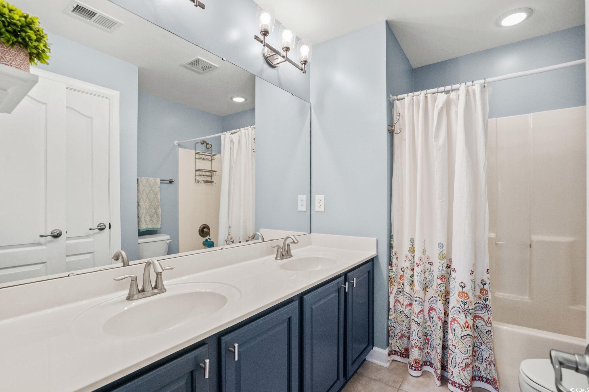 318 Barlow Court Conway, SC 29526 - Photo 23 of 36 Full bath featuring double vanity, shower / tub combo with curtain, light tile patterned floors, and recessed lighting