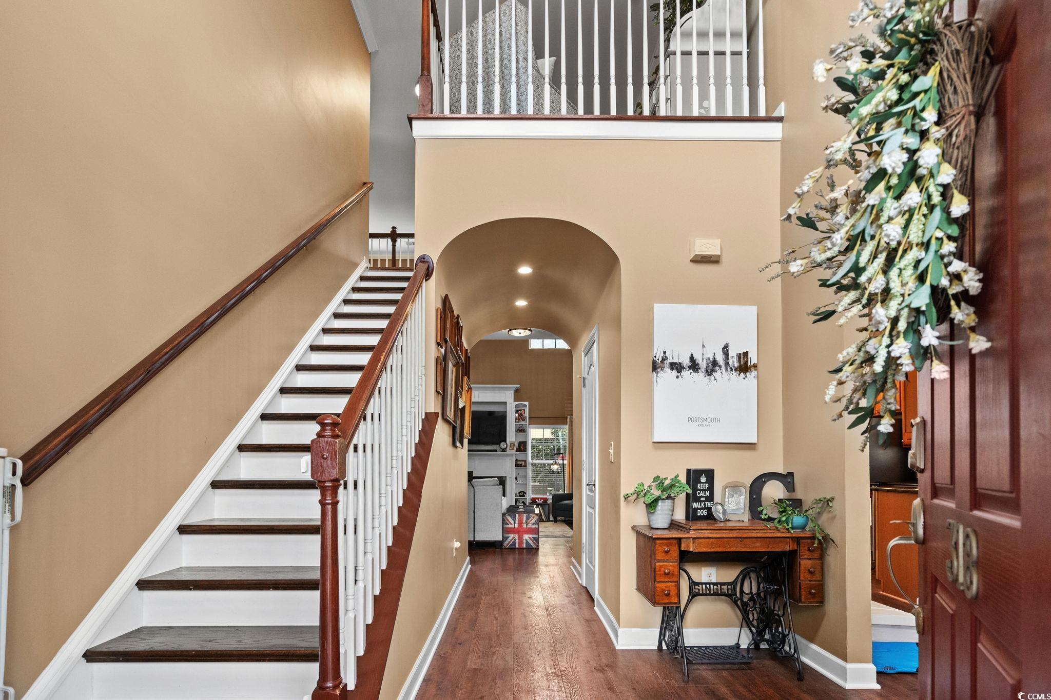318 Barlow Court Conway, SC 29526 - Photo 3 of 36 Foyer entrance with arched walkways, dark wood-type flooring, a towering ceiling, and stairway
