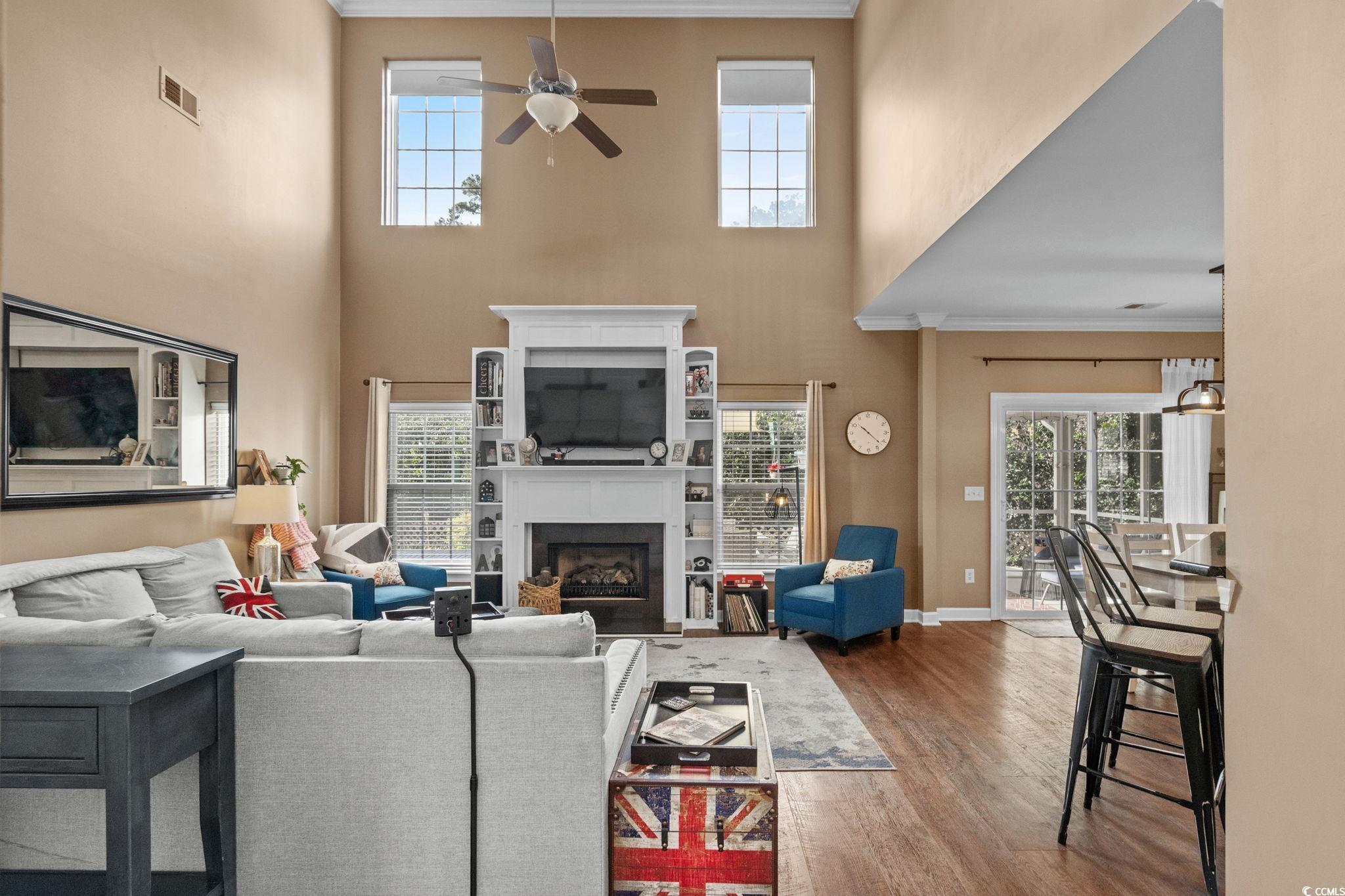 318 Barlow Court Conway, SC 29526 - Photo 5 of 36 Living area featuring ornamental molding, a fireplace, dark wood finished floors, plenty of natural light, and a towering ceiling