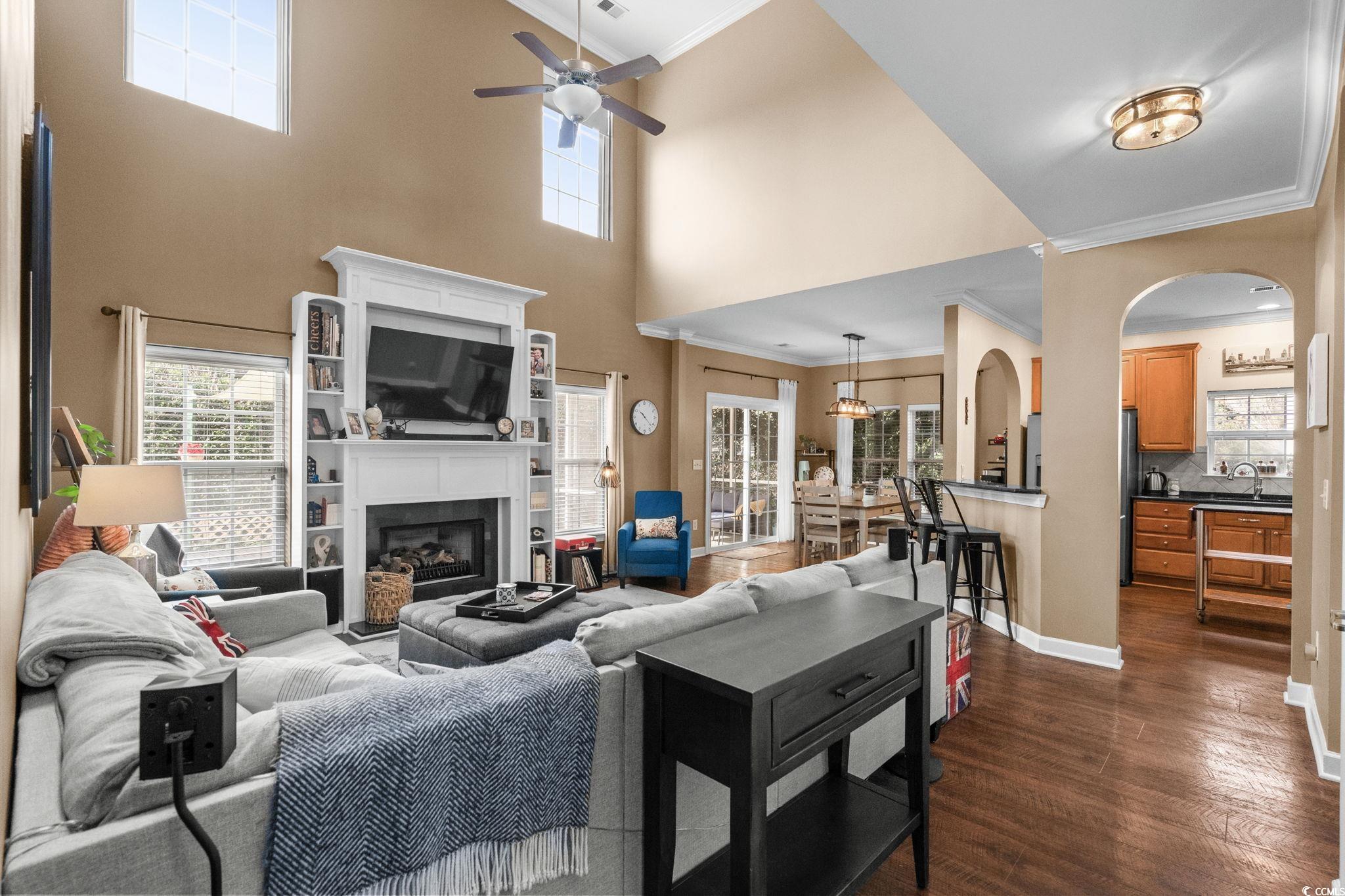 318 Barlow Court Conway, SC 29526 - Photo 6 of 36 Living room with ornamental molding, a fireplace, dark wood finished floors, and a ceiling fan
