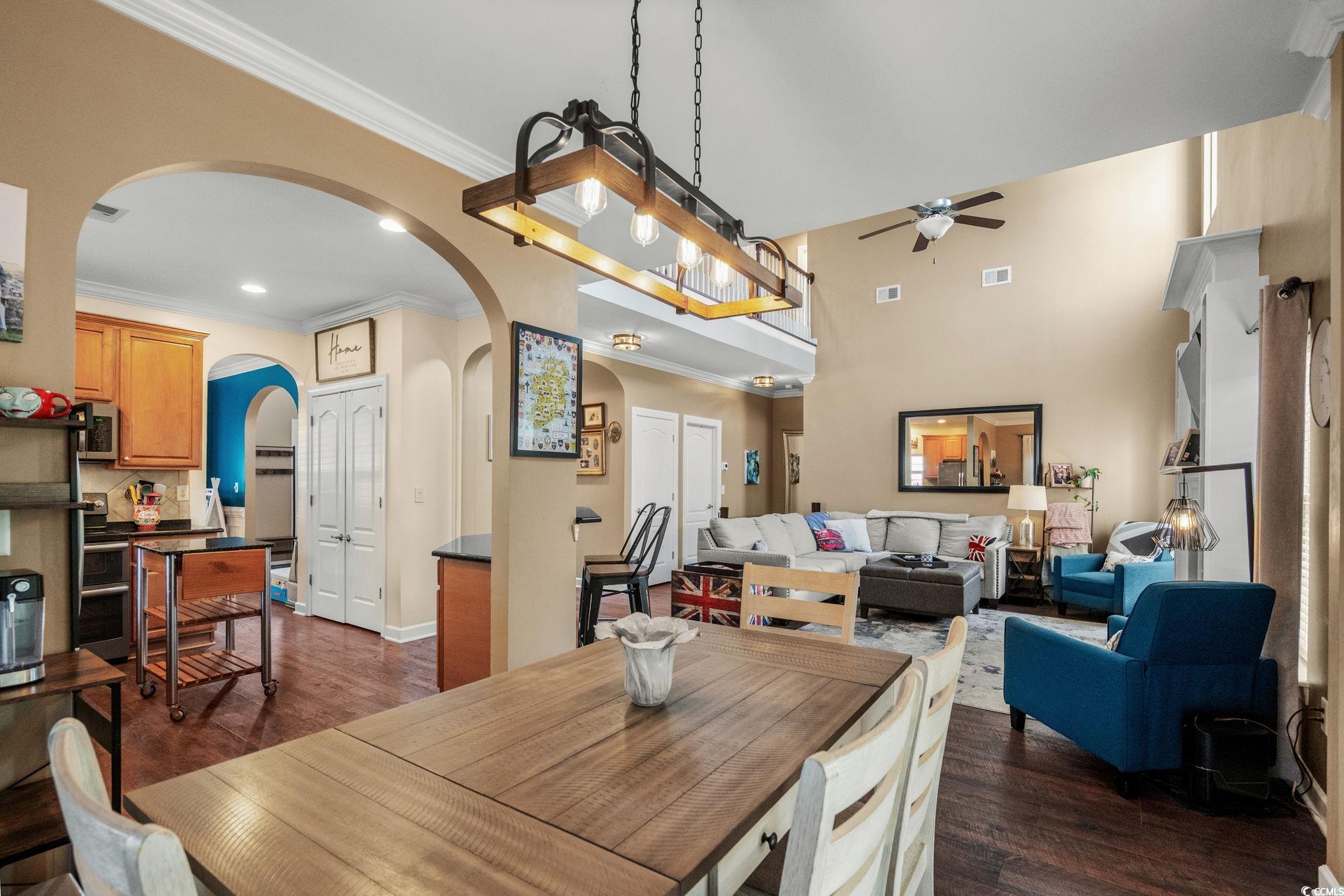 318 Barlow Court Conway, SC 29526 - Photo 10 of 36 Dining area with ornamental molding, dark wood-style flooring, and a ceiling fan
