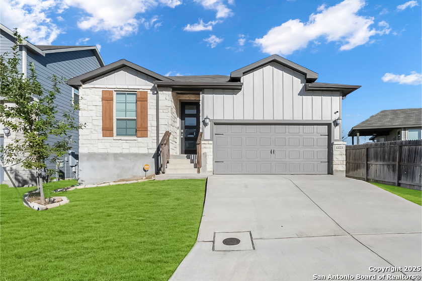 13223 Prospector Way St. Hedwig, TX 78152 - Photo 1 of 30 a front view of a house with a yard and garage