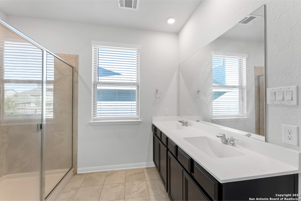 13223 Prospector Way St. Hedwig, TX 78152 - Photo 21 of 30 a bathroom with a sink and a mirror