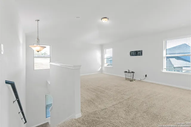 a view of an empty room with windows