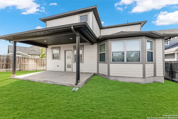 a view of an house with backyard and porch