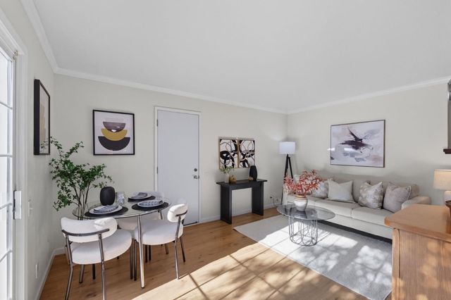a living room with furniture and flowers