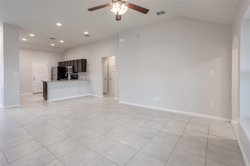 615 Stampede Road San Marcos, TX 78666 - Photo 19 of 26 An open concept living area seamlessly connects to the kitchen, perfect for daily living and entertaining.