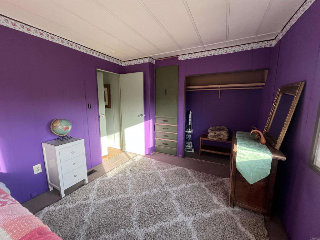 1810 Hillsdale Road, Unit 99 El Cajon, CA 92019 - Photo 12 of 15 a bed room with a bed and a chair