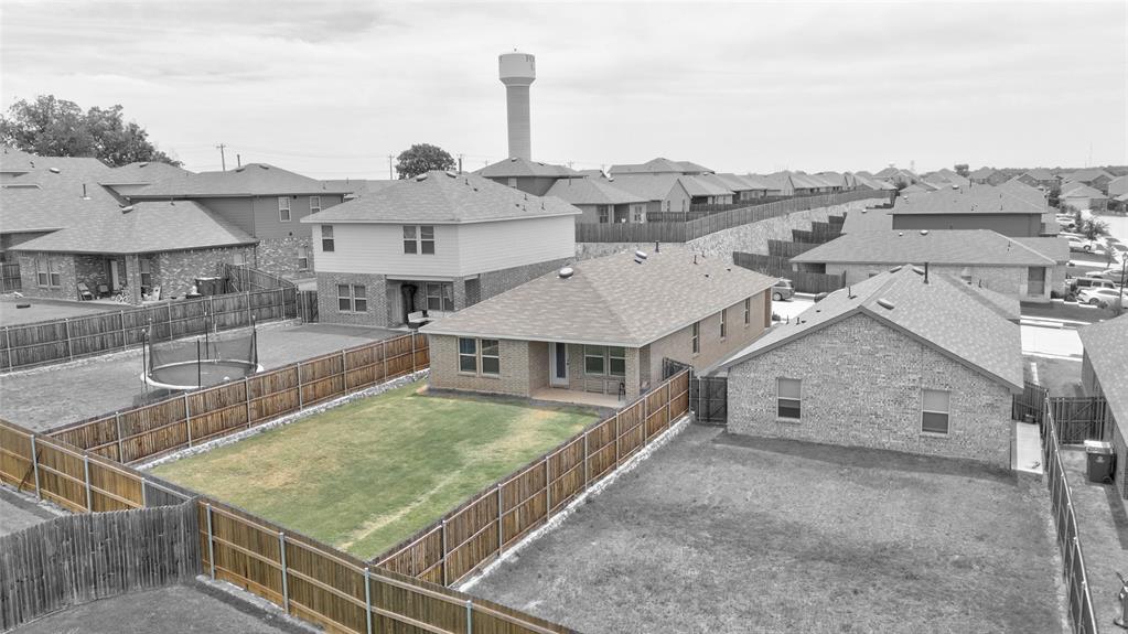 1016 Rio Bravo Drive Forney, TX 75126 - Photo 17 of 25 Spacious backyard with a wood privacy fence, featuring a manicured lawn and an uncovered patio