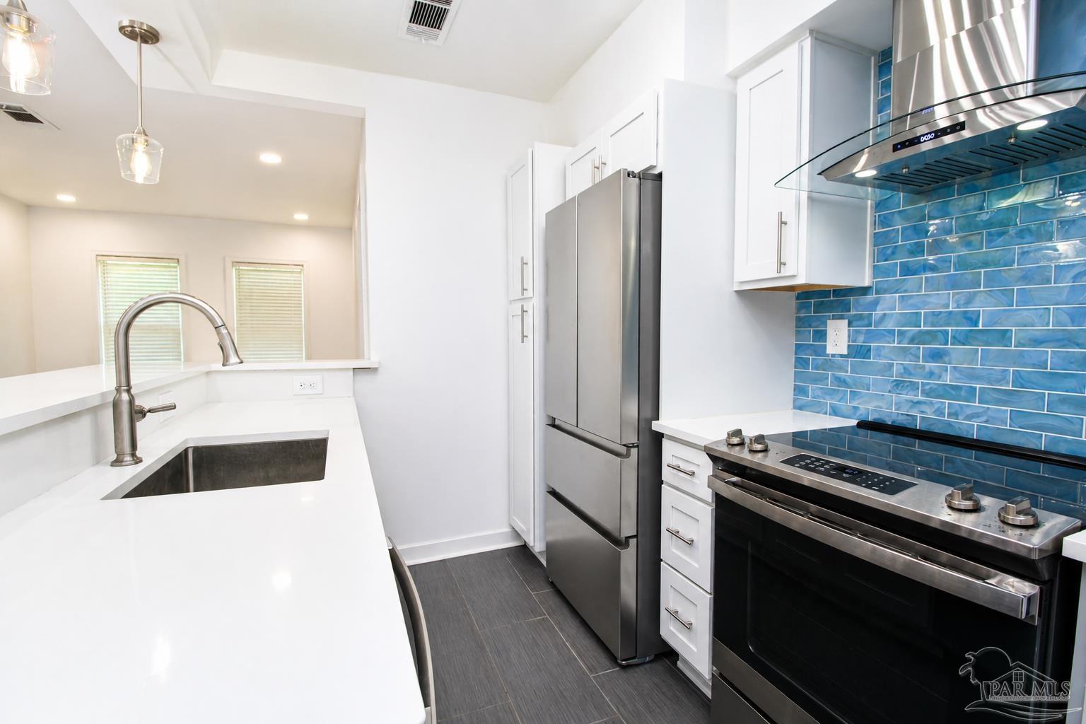 315 Flannan Road Pensacola, FL 32507 - Photo 8 of 17 a kitchen with a sink stove and refrigerator