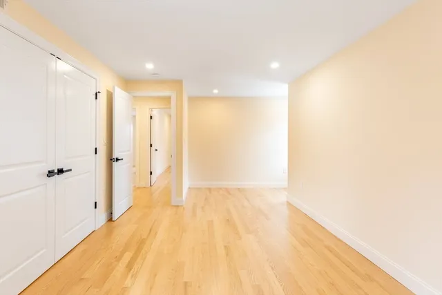 a view of a hallway with wooden floor