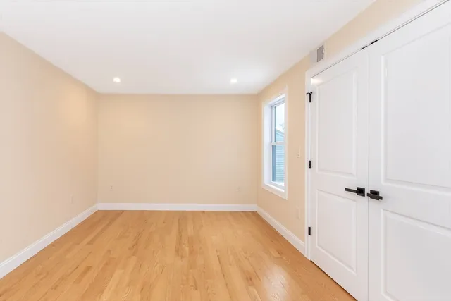 a view of a room with wooden floor and closet