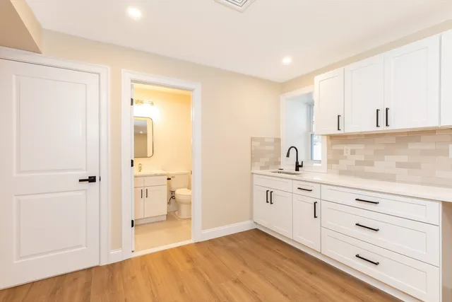 a spacious bathroom with a sink a mirror and a toilet