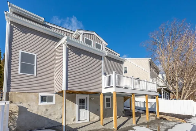 a view of a white house with large windows
