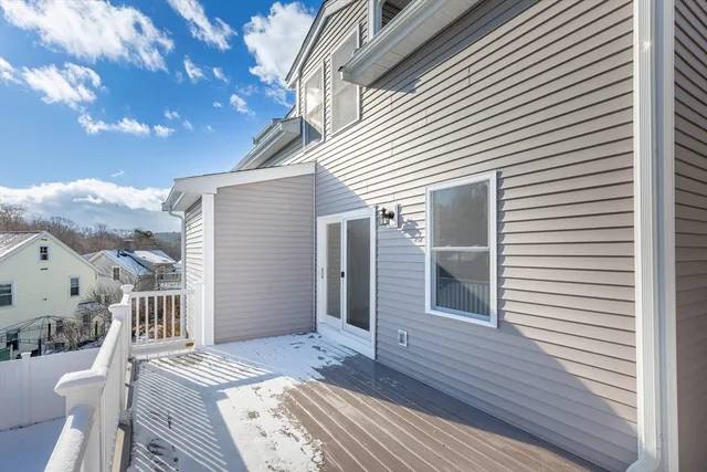 a view of a house with a wooden deck