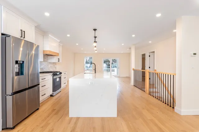 a kitchen with stainless steel appliances a refrigerator and a stove top oven