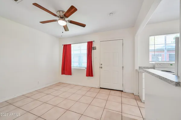 a workspace with a ceiling fan and a window