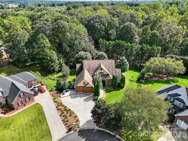 an aerial view of a house with a yard basket ball court and outdoor seating