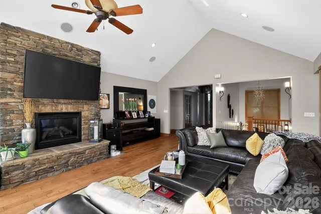 a living room with furniture fireplace and flat screen tv