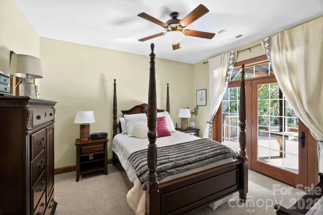 a bedroom with a bed a flat screen tv and a fireplace