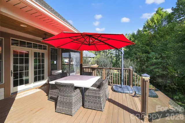 a view of a patio with a table and chairs under an umbrella